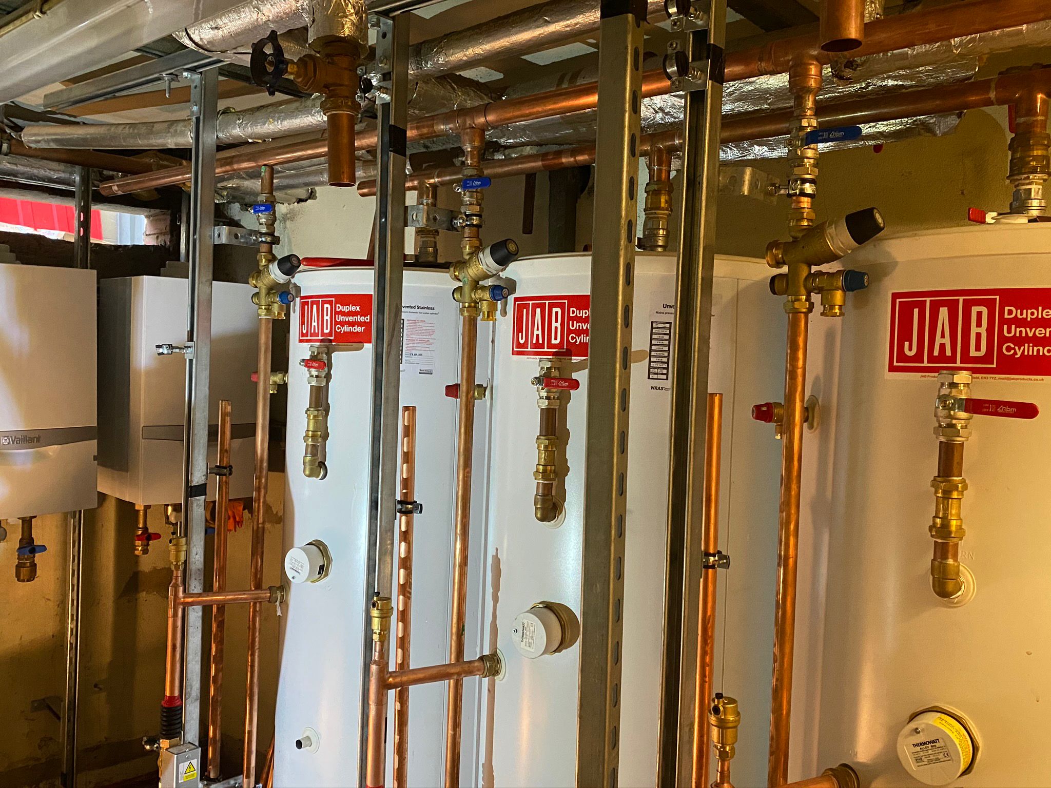 Pluto Gas central heating installation with copper pipework and hot water cylinders